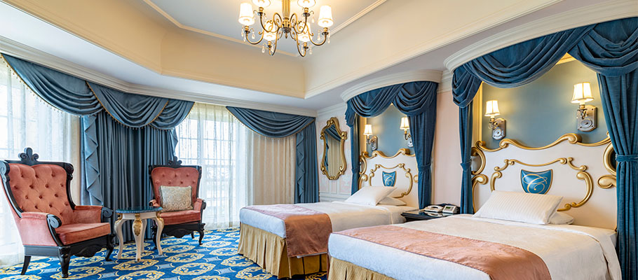 Example Cinderella Room with blue decor, twin beds and a sitting area by the windows